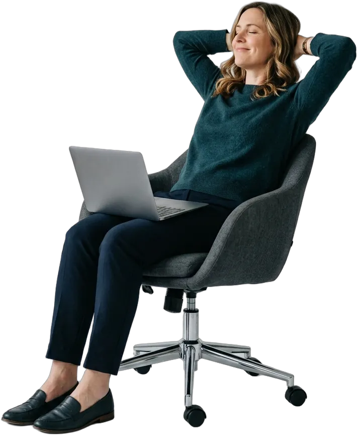 A business owner leaning back in her chair with her laptop, relaxed because the work is handled