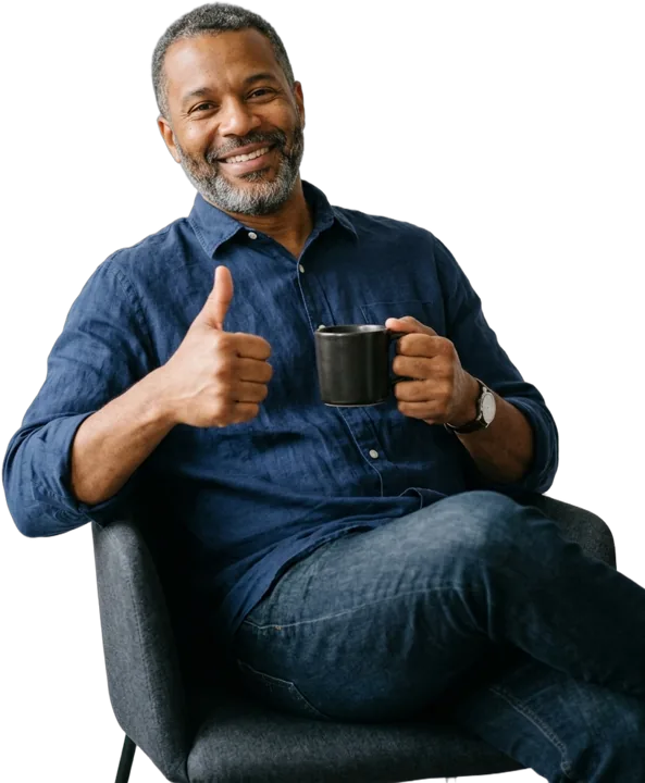 A smiling business owner with a coffee, giving a thumbs up