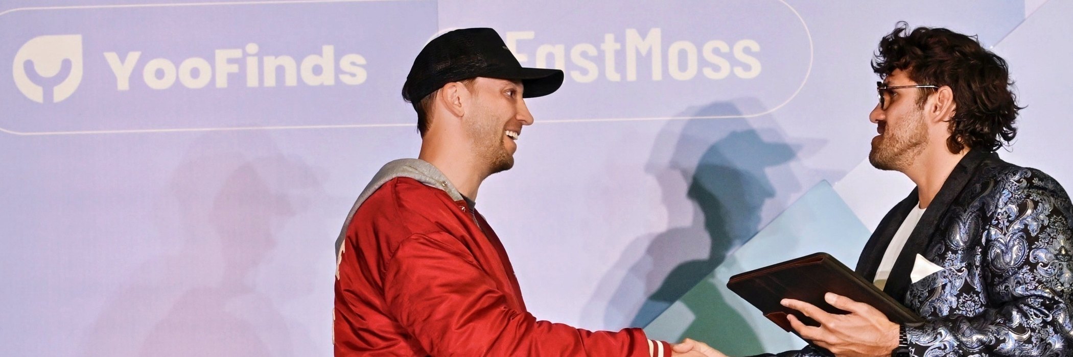 Reef shaking hands with a creator on stage
