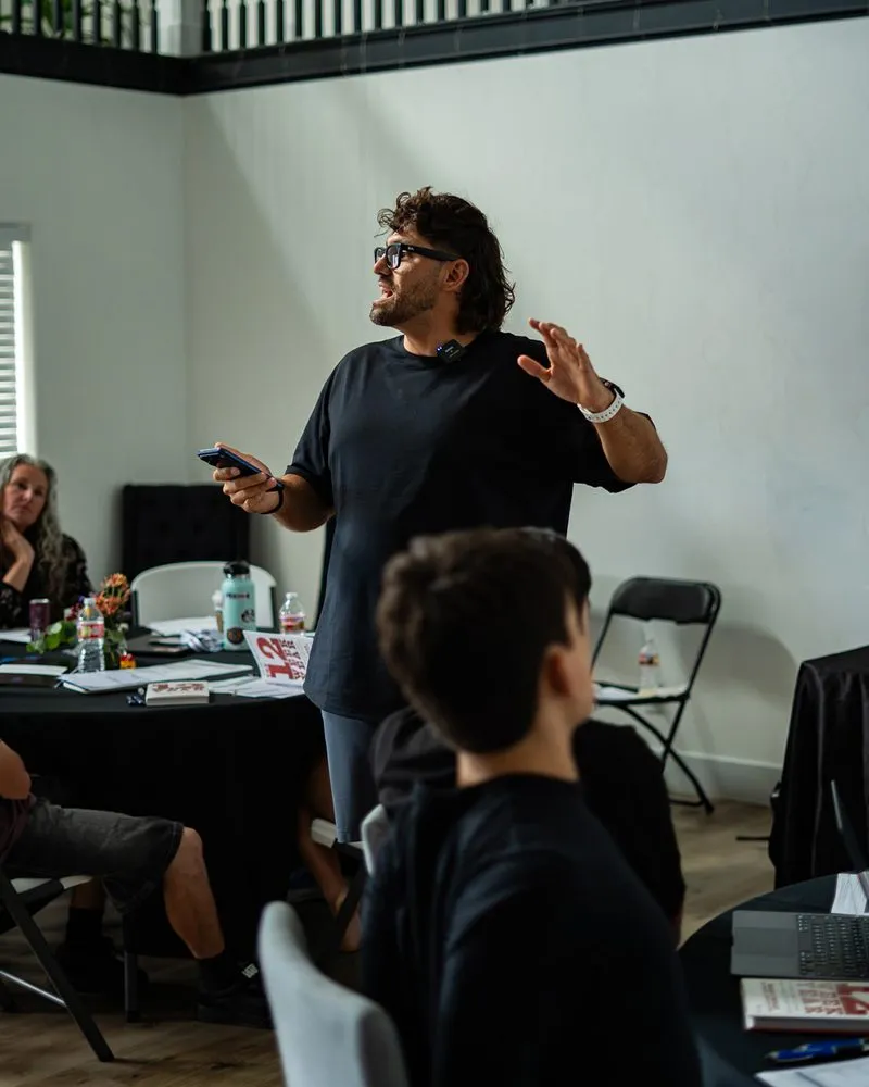 Reef Colman teaching a workshop, on stage, and at his laptop