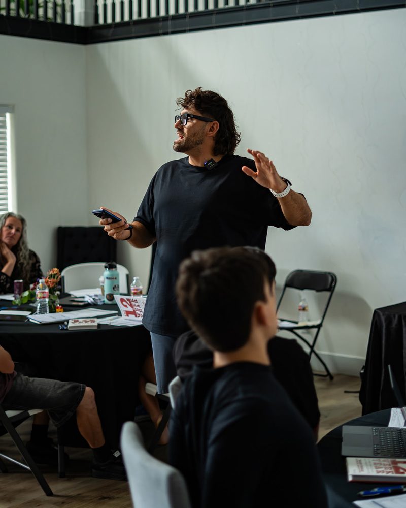 Reef Colman teaching a workshop, on stage, and at his laptop
