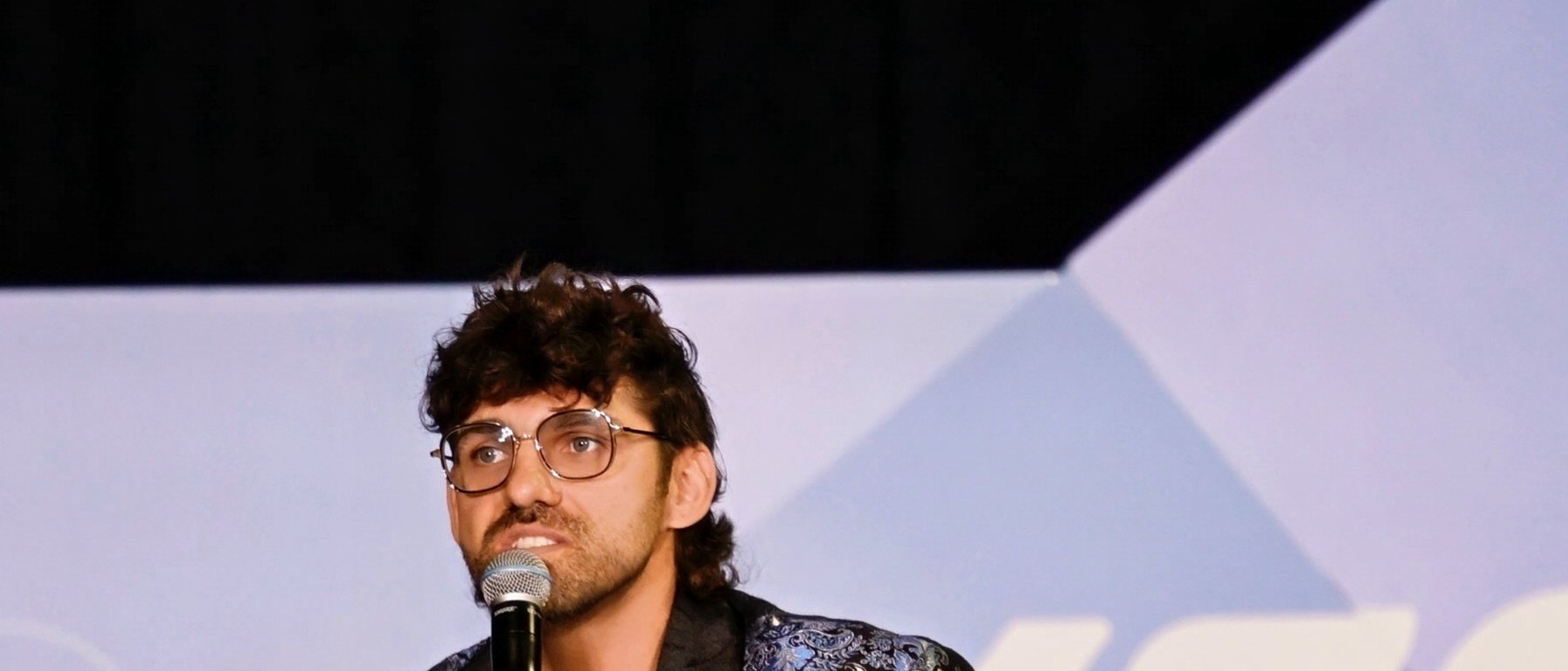 Reef Colman speaking to a room at a conference