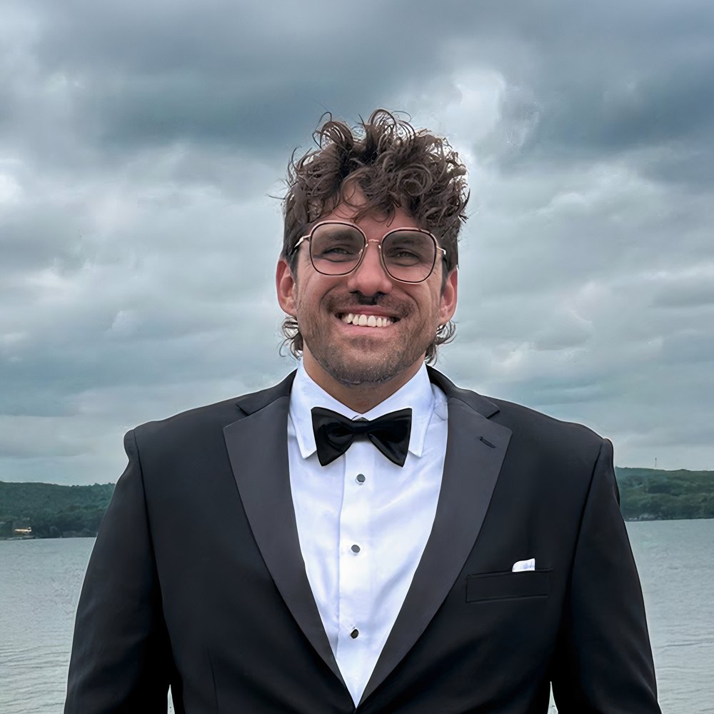 Reef in black tie beside a lake