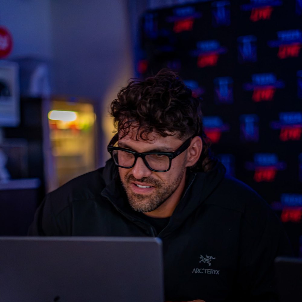 Reef working late, lit by his laptop screen