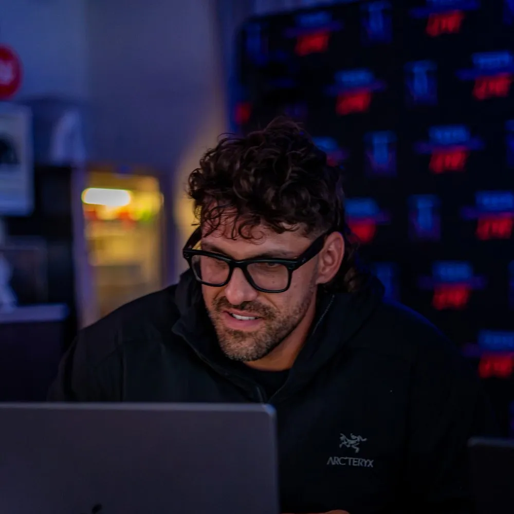 Reef working late, lit by his laptop screen